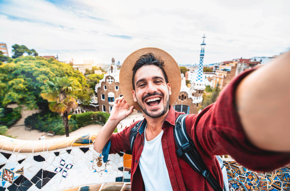 happy-tourist-take-selfie-selfportrait-with-smartphone-park-guell-barcelona-spain
